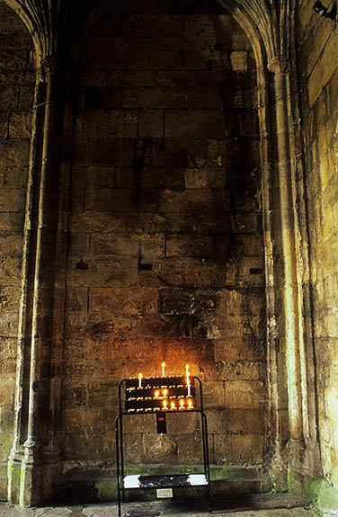 WAL: Flintshire County, Clwydian Hills, Holywell, St. Winifride's Well. Candles burning to St. Winifrede inside the crypt containing the holy well [Ask for #246.059.]