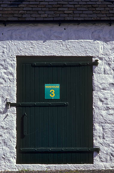 SCO: Argyll & Bute , Inner Hebrides, Islay, Port Ellen, Port Ellen Distillery and Maltings. Bonded warehouse door, built in early 19th cent. of stone, used to store aging casks of whiskey [Ask for #246.368.]