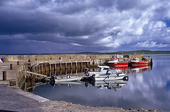 SCO: Argyll & Bute , Inner Hebrides, Islay, Bowmore, Fishing boats in Bowmore Harbor, with a storm approaching over Loch Indaal [Ask for #246.426.]