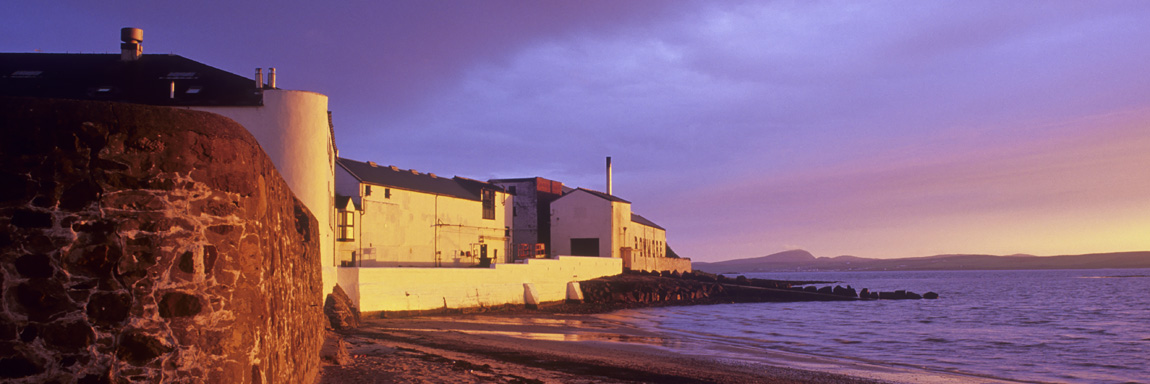 SCO: Argyll & Bute , Inner Hebrides, Islay, Bowmore, Sunset view from harbor towards the Bowmore Distillery [Ask for #246.507.]