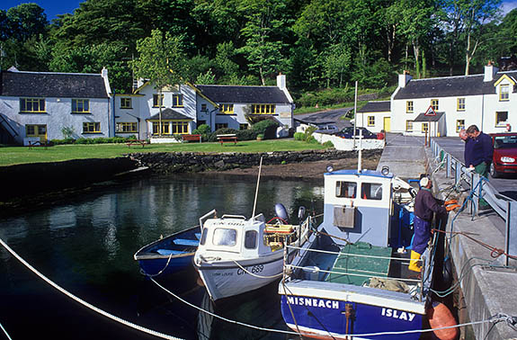 SCO: Argyll & Bute , Inner Hebrides, Islay, Port Askaig, Tiny village viewed from its harbor; fishermen talking on quay [Ask for #246.516.]