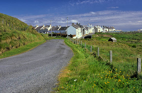 SCO: Argyll & Bute , Inner Hebrides, Islay, Portnahaven, View down country lane towards fishing village [Ask for #246.549.]