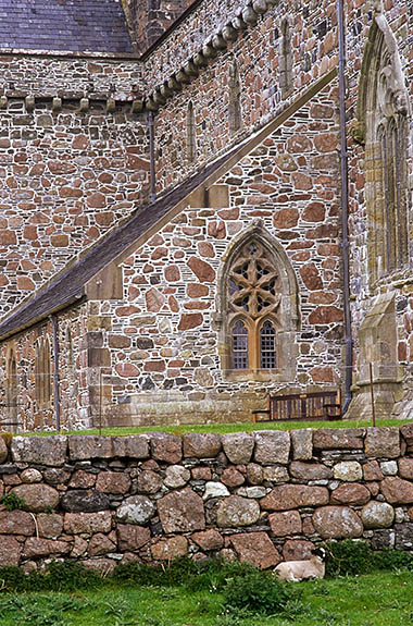 SCO: Argyll & Bute , Inner Hebrides, off Mull, Isle of Iona, Iona Abbey. The Abbey (13th/20th C); lamb shelters from the wind under the walls of the restored abbey. [Ask for #246.584.]