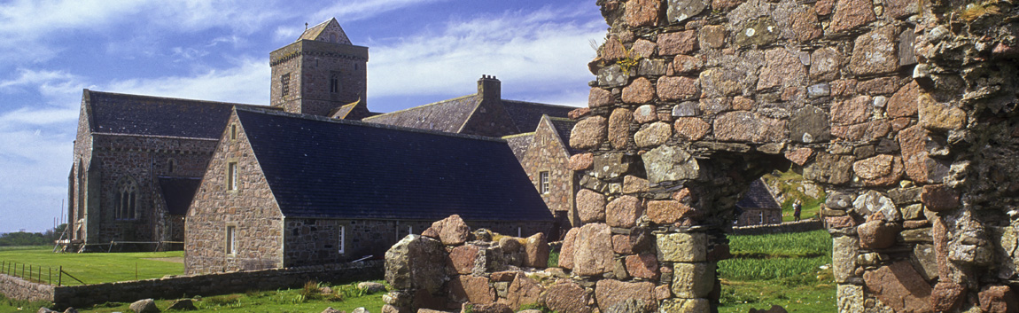 SCO: Argyll & Bute , Inner Hebrides, off Mull, Isle of Iona, Iona Abbey. View from the ruins of the Tigh an Easbuig (17th C Bishop's House) towards the restored 13th C. abbey [Ask for #246.588.]