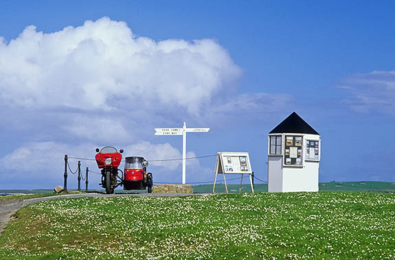 SCO: Highland Region, Caithness District, Northern Coast, John o' Groats, Booth offering to take your picture beside a fake road sign at this tourist spot. [Ask for #246.783.]