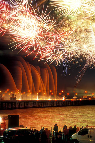 ENG: Blackpool Borough, Central City, Historic Town Center, International Fireworks Competition at the Illuminations Festival; people crowd along the seawall as fireworks explode over the pier [Ask for #262.082.]