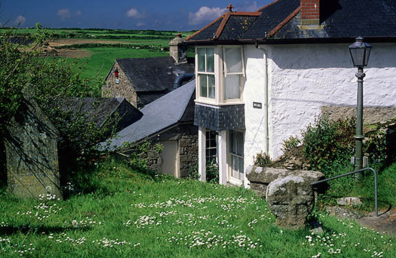 ENG: Cornwall , Cornwall AONB, Penwith Peninsula, Zennor Area. Stone cottage in rolling farmlands; gravestones by gate [Ask for #268.218.]