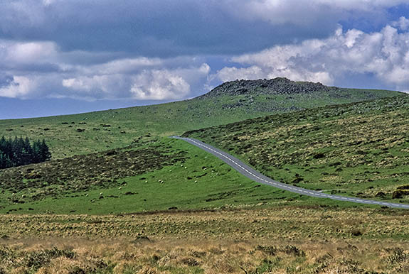 ENG: South West Region, Devon, Dartmoor National Park, Central Dartmoor, Princetown, A road crosses the high moor known as Walkhampton Common, west of town; Leeden Tor in bkgd; no traffic [Ask for #268.569.]