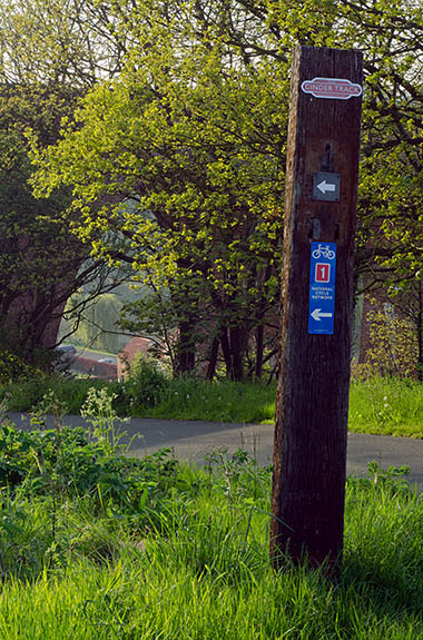 ENG: Yorkshire & Humberside Region, North Yorkshire, North Yorkshire Coast, Whitby, The Cinder Track, a rail-trail, Signpost on an old railroad tie; River Esk Viaduct in bkgd [Ask for #270.207.]