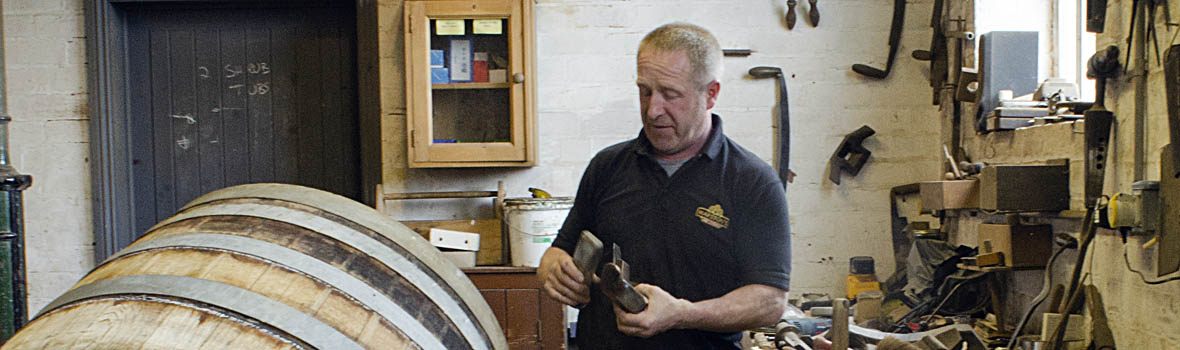 ENG: West Midlands Region, Staffordshire, The Trent Valley, Burton-on-Trent, Marstons Brewery, Shobnall, Mark Newton, Marston's cooper; workshop, as he scrapes the inside of a barrel. [Ask for #270.231.]