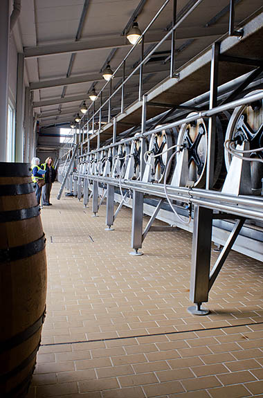 ENG: West Midlands Region, Staffordshire, The Trent Valley, Burton-on-Trent, Marstons Brewery, Shobnall, Emma Gilleland (rt), head brewer, explains to a visitor the Burton Union System of fermenting, in which the beer is racked through a series of 26 wood barrels. [Ask for #270.234.]