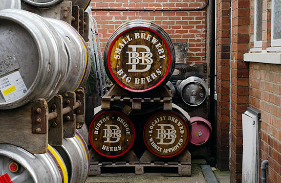 ENG: West Midlands Region, Staffordshire, The Trent Valley, Burton-on-Trent, Burton Bridge Brewery, Town Center, Casks and wooden barrels stacked behind the brewery, waiting to be shipped. [Ask for #270.239.]