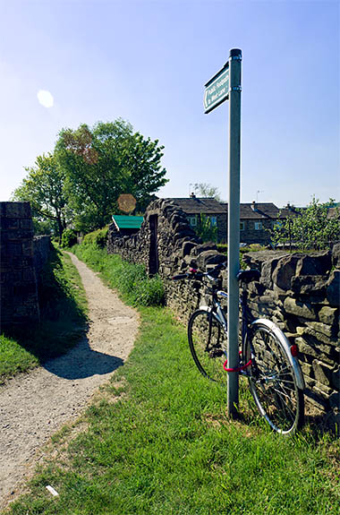ENG: Yorkshire & Humberside Region, West Yorkshire, Bradford Borough, Haworth, Bronte Parsonage Museum, Signpost behind the parsonage points up a footpath to the open moors [Ask for #270.333.]